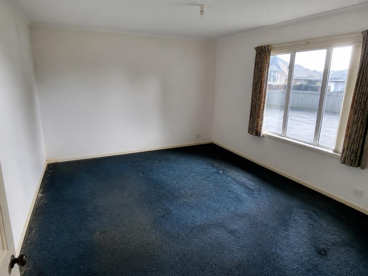 Primary bedroom before new flooring